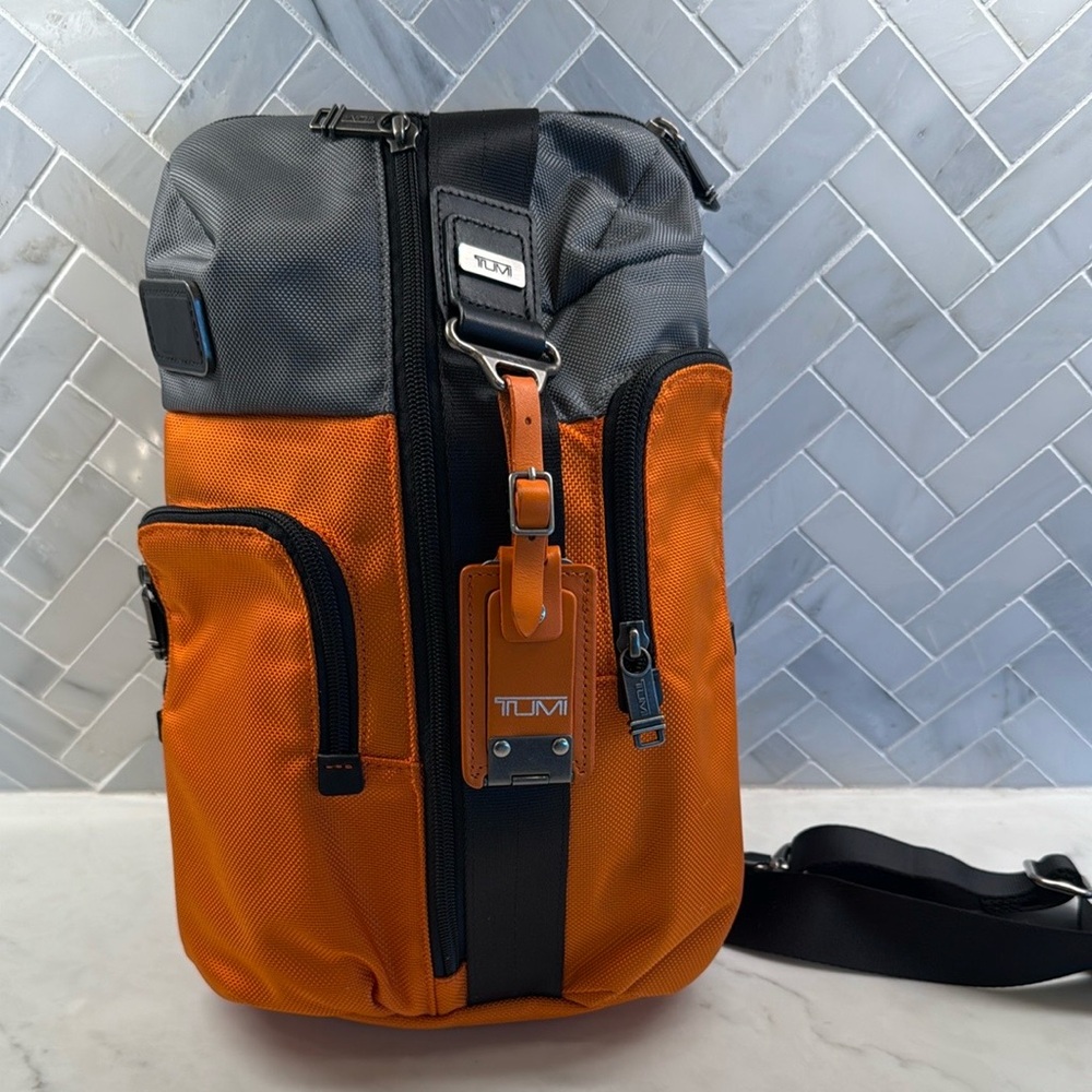 Tumi Orange and Gray Backpack with Modern Design